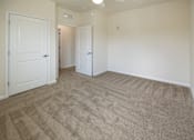 Thumbnail 11 of 21 - A room with carpeted floor and white walls.