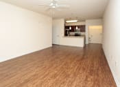 Thumbnail 10 of 21 - A room with wooden flooring and a ceiling fan.