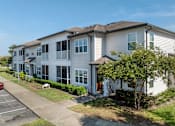 Thumbnail 3 of 21 - A row of townhouses with a clear blue sky above.