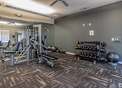 Thumbnail 15 of 21 - A gym with a variety of equipment and weights.