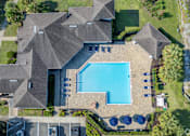 Thumbnail 5 of 21 - A large house with a pool in the backyard.