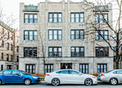 Thumbnail 3 of 24 - Three cars parked in front of a building.
