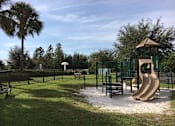 Thumbnail 16 of 44 - A playground with a slide and a wooden structure.