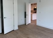Thumbnail 12 of 24 - A white door is open to a kitchen.