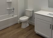 Thumbnail 13 of 24 - A white bathroom with a toilet, sink, and bathtub.
