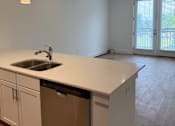 Thumbnail 7 of 24 - A kitchen with a sink and cabinets.