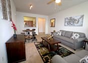 Thumbnail 2 of 44 - A living room with a grey couch and a wooden coffee table.