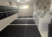 Thumbnail 23 of 24 - A clean, empty laundry room with a washer and dryer.