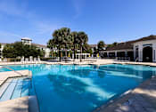 Thumbnail 13 of 44 - A large swimming pool with a blue tinted water.