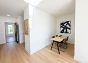 Thumbnail 19 of 84 - A room with a table and chairs and two pieces of artwork on the wall.