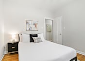 Thumbnail 12 of 27 - A white bed with a white pillow and a white blanket.