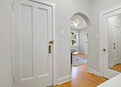 Thumbnail 6 of 27 - A white door with a gold handle is open.
