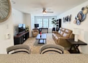 Thumbnail 41 of 48 - A living room with a couch and a chair.