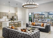 Thumbnail 20 of 46 - A modern living room with a grey tufted sofa and a chandelier.