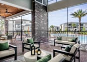 Thumbnail 25 of 46 - A patio with a pool and a view of apartment buildings.