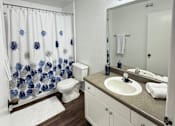 Thumbnail 44 of 48 - A bathroom with a white toilet and a white sink.