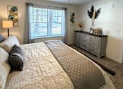 Thumbnail 43 of 48 - A bedroom with a large bed and a ceiling fan.