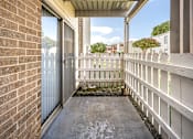 Thumbnail 20 of 24 - A small balcony with a white railing and a brick wall.