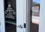 Thumbnail 36 of 46 - A glass door with a sign that says No smoking or vaping
