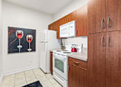 Thumbnail 8 of 71 - A kitchen with brown cabinets and a fridge.
