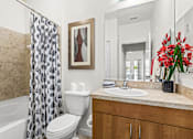 Thumbnail 16 of 71 - A bathroom with a toilet, sink, and shower.