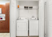 Thumbnail 17 of 71 - A small laundry room with a washer and dryer.