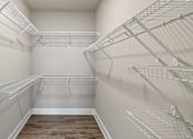 Thumbnail 42 of 46 - Empty walk-in pantry with white walls and shelving.