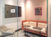 Thumbnail 22 of 44 - A glass wall separates a meeting room from a hallway.