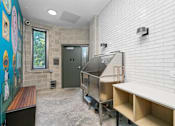Thumbnail 28 of 44 - A kitchen area with a stainless steel oven and a white brick wall.