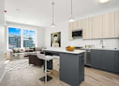 Thumbnail 8 of 44 - A modern kitchen with a large island and a view of the city.
