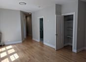 Thumbnail 11 of 19 - A room with a wooden floor and a white ceiling with a recessed lighting fixture.