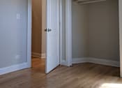 Thumbnail 7 of 19 - A room with a white door and a brown door.