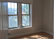 Thumbnail 5 of 19 - A room with a ceiling fan and a window with sunlight coming through.