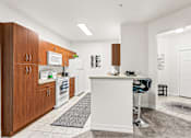 Thumbnail 22 of 71 - A kitchen with white appliances and wooden cabinets.