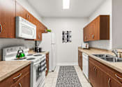 Thumbnail 19 of 71 - A kitchen with white appliances and wooden cabinets.