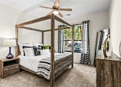Thumbnail 29 of 71 - A bedroom with a four poster bed and a ceiling fan.