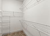 Thumbnail 27 of 50 - Empty white shelves in a room.