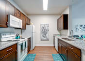 Thumbnail 35 of 71 - A kitchen with a white fridge and a white stove.