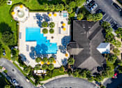 Thumbnail 39 of 44 - A large building with a pool in front of it.