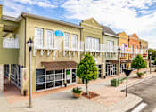 Thumbnail 65 of 71 - A street view of a shopping area with a blue sign on the building.