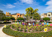 Thumbnail 46 of 50 - A colorful garden with the word "LASG" spelled out in decorative letters.