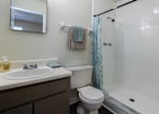 Thumbnail 5 of 24 - A bathroom with a white sink, toilet, and shower.