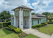 Thumbnail 1 of 21 - A white house with a brown roof and a green lawn.