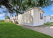 Thumbnail 10 of 14 - Exterior view of model home at Candlelight Village Manufactured Home Community in Sauk, IL
