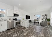 Thumbnail 4 of 19 - the living room and kitchen of a home with white cabinets and stainless steel appliances
