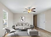 Thumbnail 2 of 14 - Model living room with couch and ceiling fan at Candlelight Village Manufactured Home Community in Sauk, IL