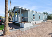 Thumbnail 18 of 19 - Model home exterior at Desert Valley Oasis MHC in Mesa, AZ.