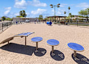 Thumbnail 21 of 23 - Fenced dog park with agility equipment at Verde Plaza Manufactured Home Community in Tucson, Arizona