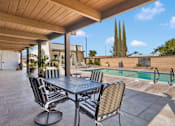 Thumbnail 12 of 23 - A patio with a table and chairs is shown.
