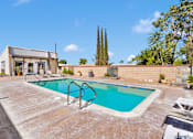 Thumbnail 11 of 23 - A small pool with a slide in a backyard.